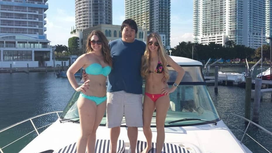 Zhong pictured with two women on a yacht.
