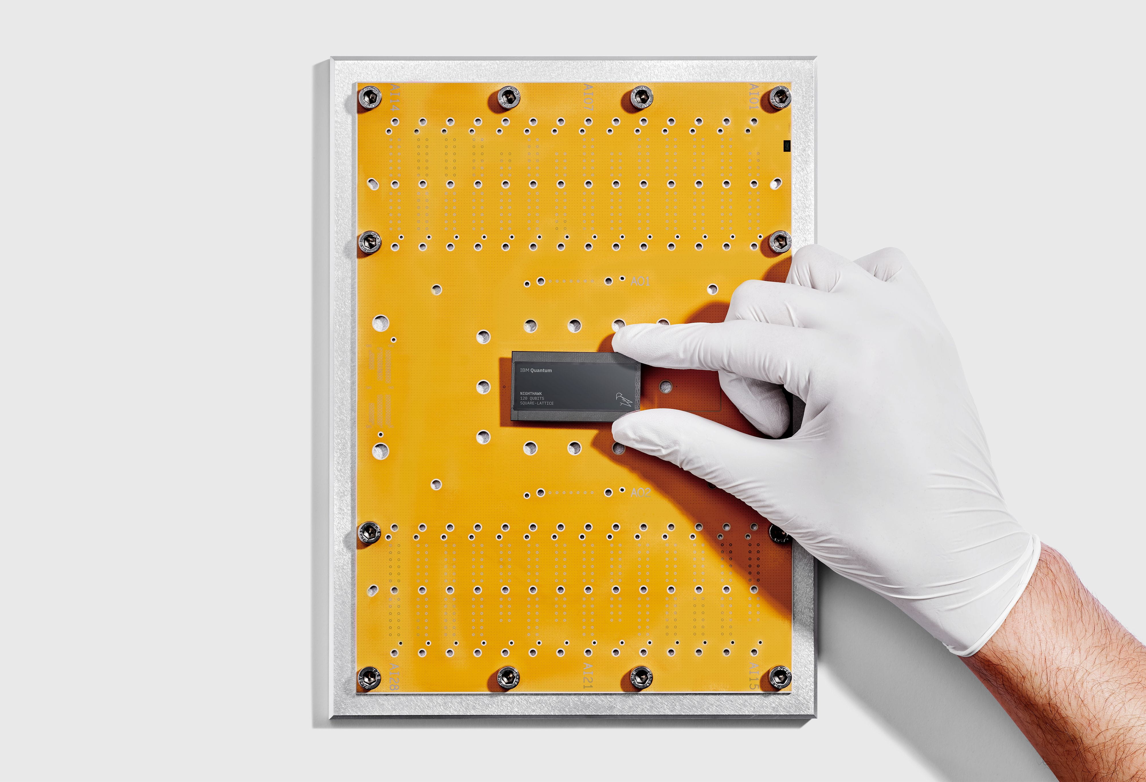 IBM researcher holds IBM Quantum Nighthawk chip (Credit: IBM)